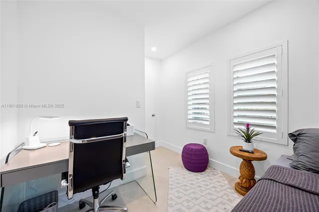 a bedroom with furniture and a flat screen tv