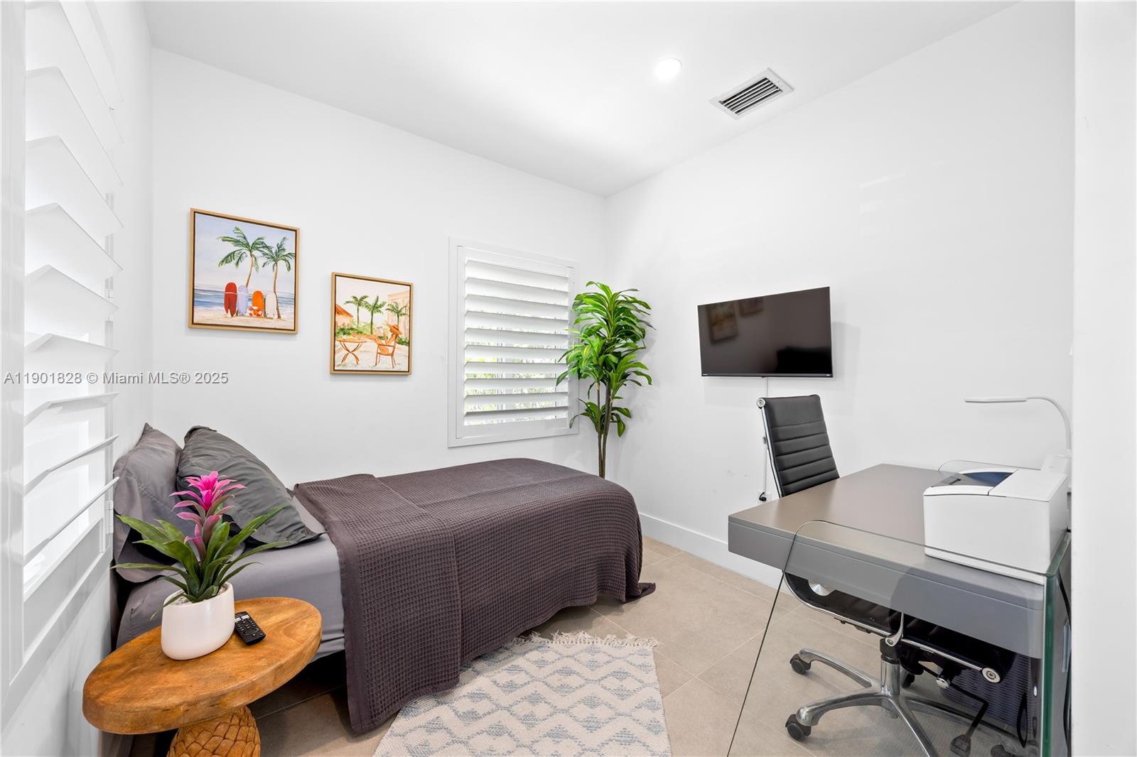 11 Northwest 45th Street Miami, FL 33127 - Photo 19 of 28 a bedroom with furniture and a flat screen tv