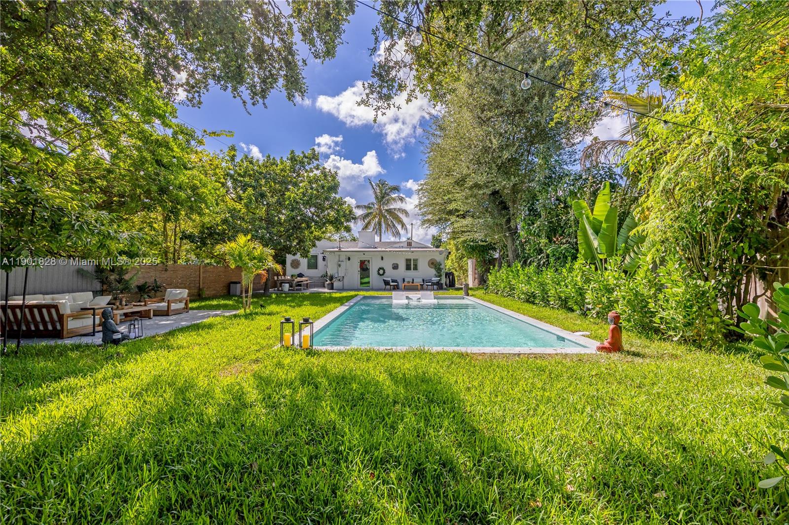11 Northwest 45th Street Miami, FL 33127 - Photo 2 of 28 a view of a swimming pool with lawn chairs and plants