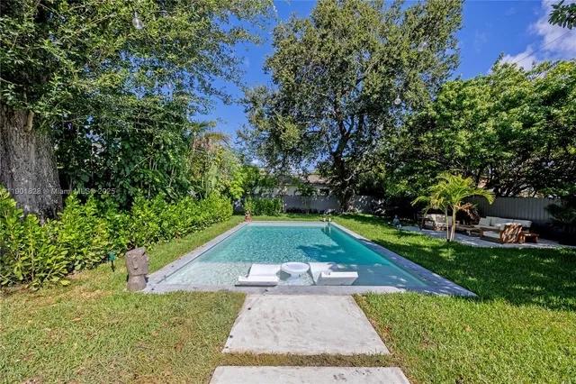 a view of backyard with swimming pool