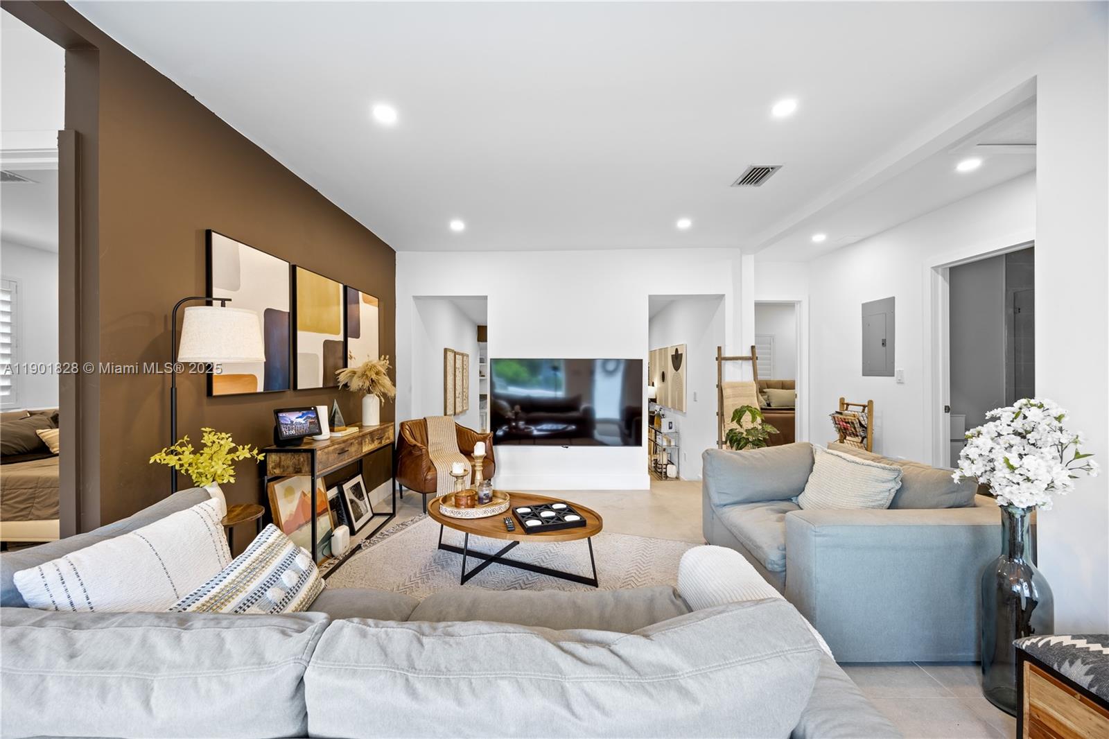 11 Northwest 45th Street Miami, FL 33127 - Photo 6 of 28 a living room with furniture and a flat screen tv