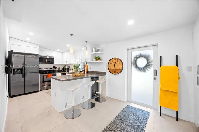 a kitchen with a refrigerator and a stove top oven