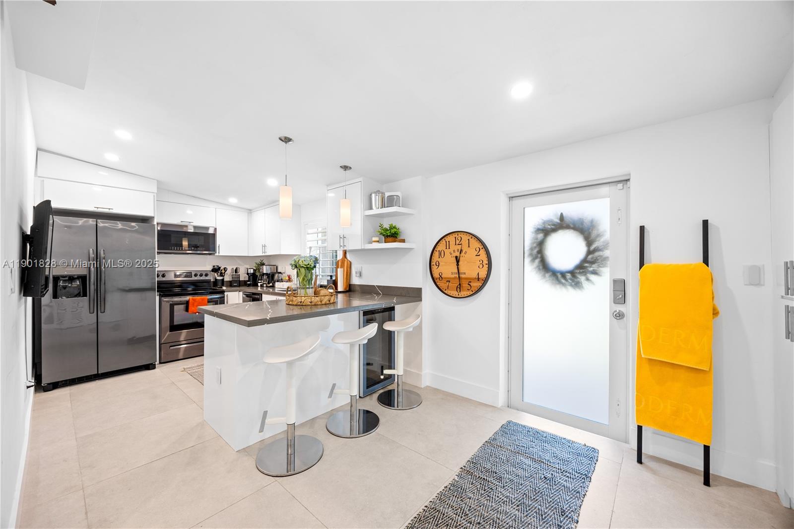 11 Northwest 45th Street Miami, FL 33127 - Photo 10 of 28 a kitchen with a refrigerator and a stove top oven