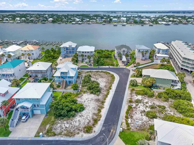 an aerial view of a house with outdoor space and lake view