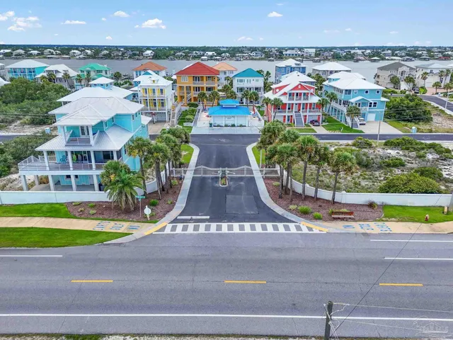 an aerial view of multiple houses with a yard