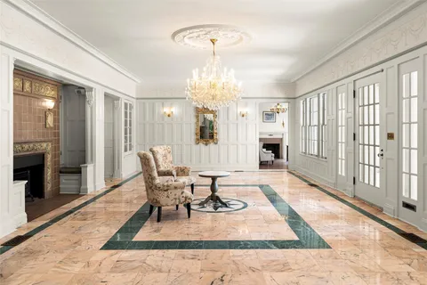 a living room with furniture and a chandelier