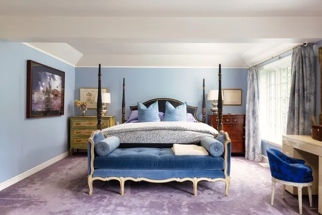 a bedroom with a bed chair and window