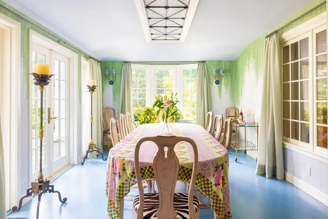 a view of a balcony with dining table and chairs