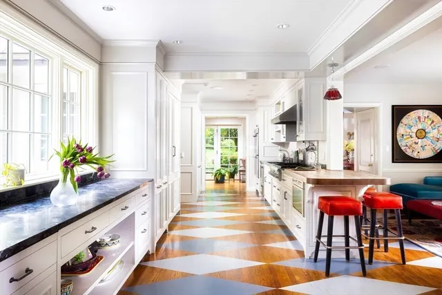 a large white kitchen with cabinets