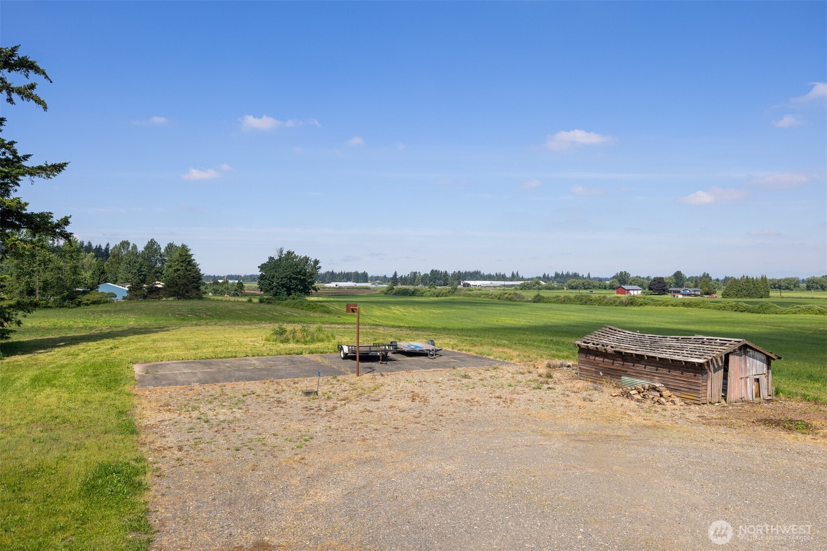 6791 Noon Road Everson, WA 98247 - Photo 38 of 38 a view of a lake with a yard and large trees