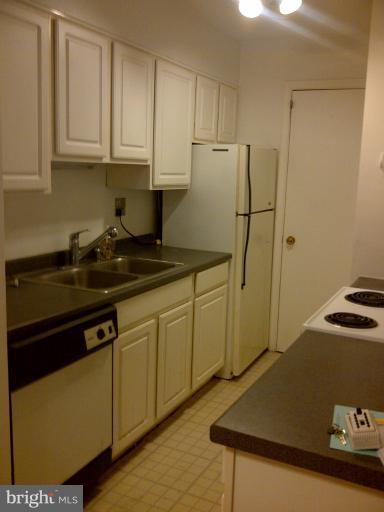 5907L Kingsford Road, Unit 402 Springfield, VA 22152 - Photo 5 of 8 a kitchen with a sink and cabinets