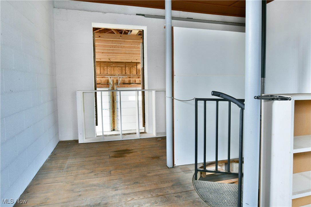 5150 Phillips Rice Road Cortland, OH 44410 - Photo 16 of 50 Hallway with hardwood / wood-style flooring and concrete block wall