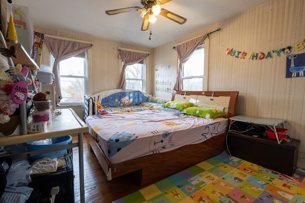 45 North Crescent Circle Sudbury, MA 01776 - Photo 11 of 16 a bedroom with a bed and a chandelier