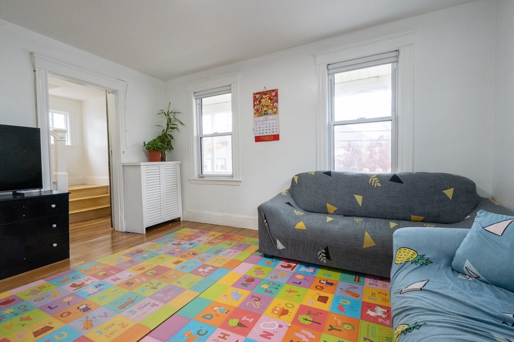 45 North Crescent Circle Sudbury, MA 01776 - Photo 2 of 16 a living room with furniture and a flat screen tv
