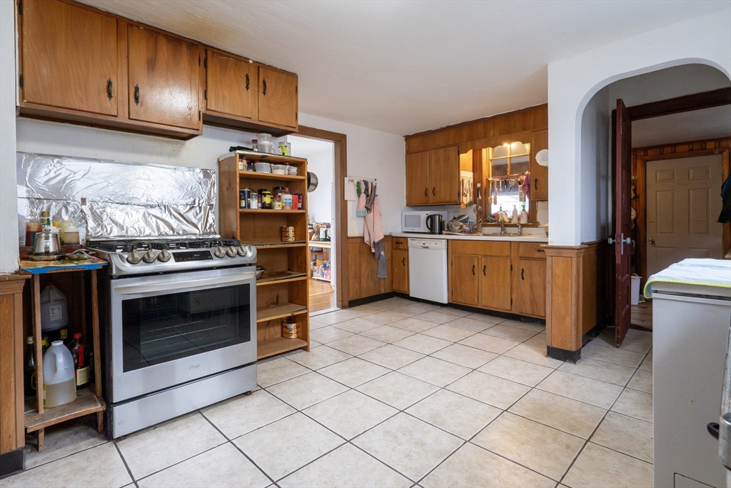 45 North Crescent Circle Sudbury, MA 01776 - Photo 5 of 16 a kitchen with stainless steel appliances granite countertop a stove top oven and cabinets