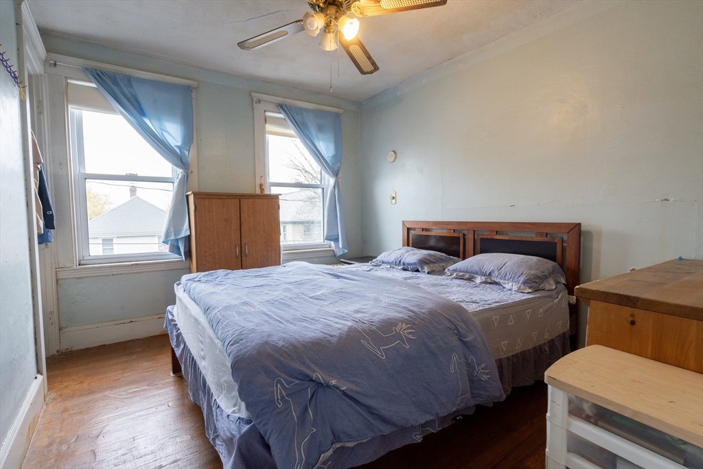 45 North Crescent Circle Sudbury, MA 01776 - Photo 10 of 16 a bedroom with a bed and a chandelier