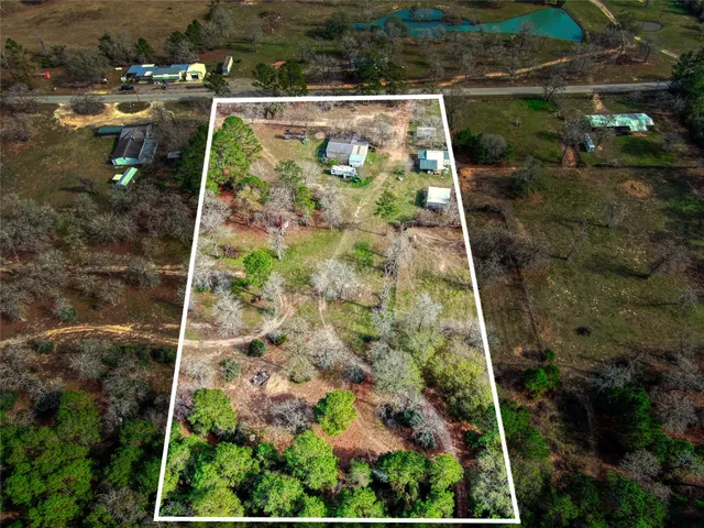 a view of a green field with sitting area
