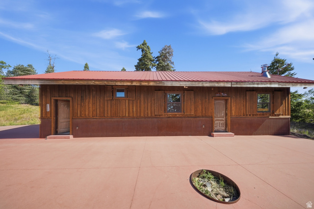 1063 West Kolob Ranch Drive Springdale, UT 84767 - Photo 44 of 61 Rustic wood-paneled exterior with a red metal roof and corrugated metal wainscoting