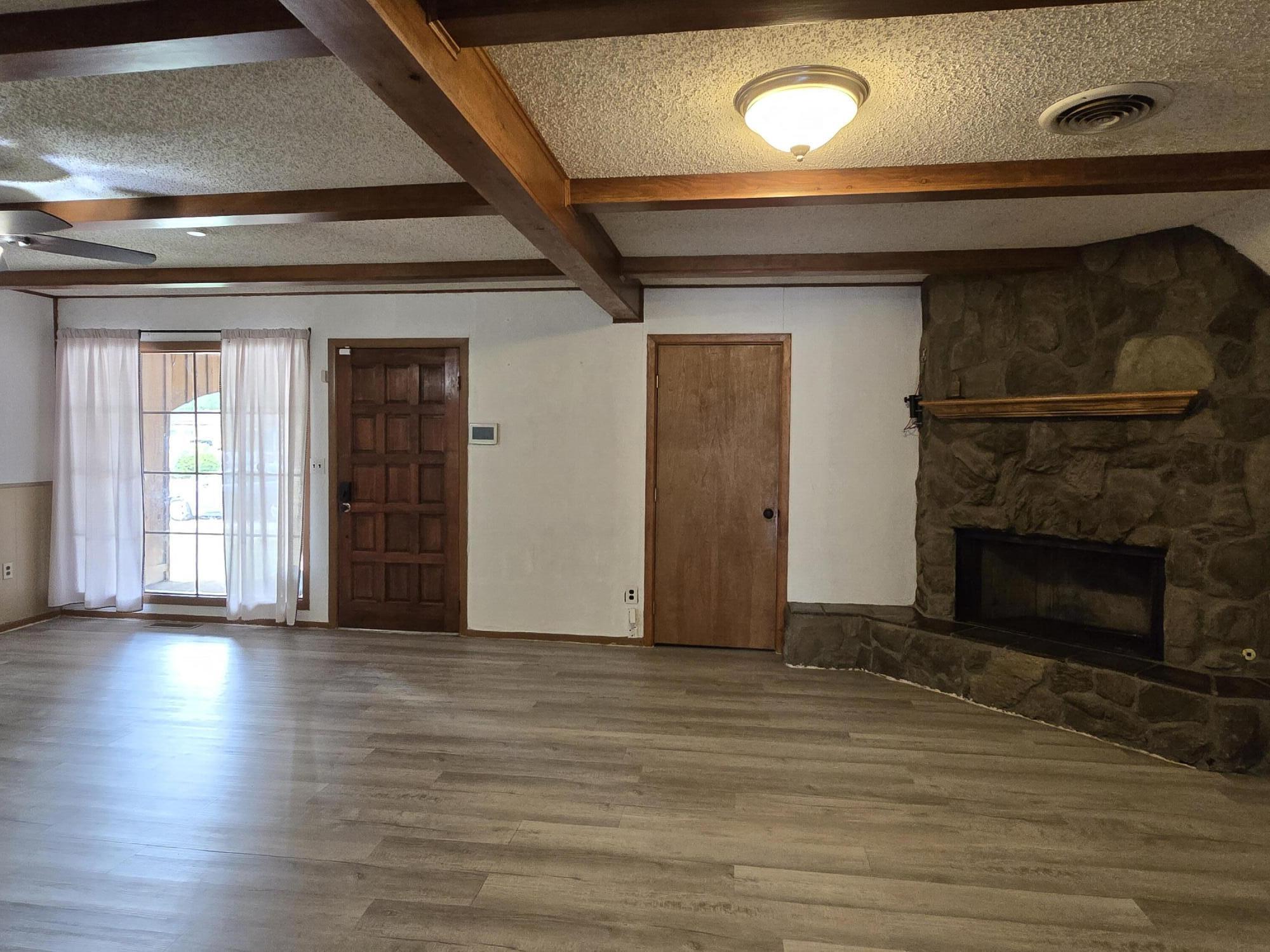 506 North 19th Street Lamesa, TX 79331 - Photo 6 of 29 a view of an empty room with wooden floor and a window