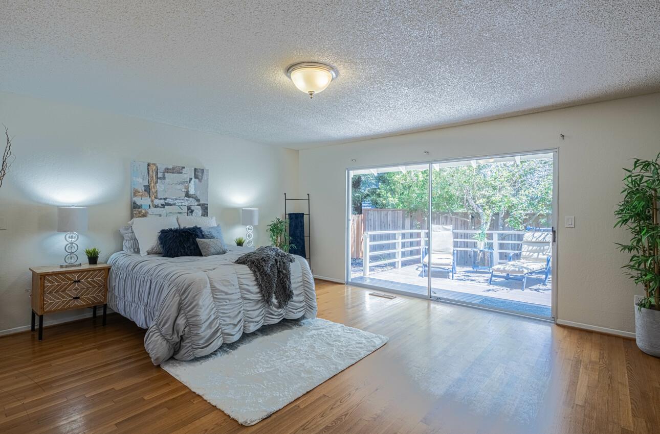 175 Tamarack Drive Aptos, CA 95003 - Photo 28 of 54 a spacious bedroom with a large bed and a large window with wooden floor