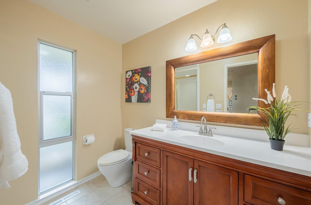 175 Tamarack Drive Aptos, CA 95003 - Photo 34 of 54 a bathroom with a granite countertop sink a toilet and a mirror