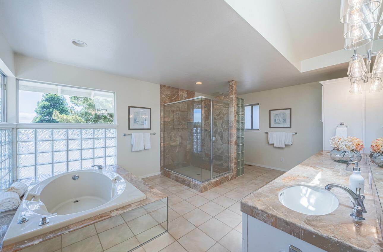 175 Tamarack Drive Aptos, CA 95003 - Photo 41 of 54 a bathroom with a tub sink toilet and mirror