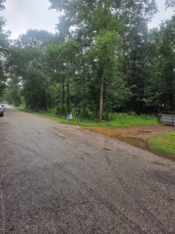 a view of a field with trees in the background