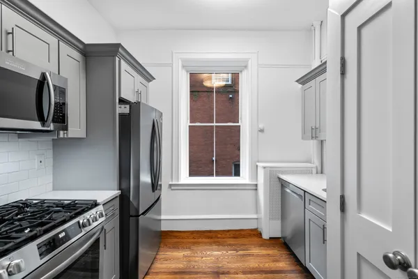 a kitchen with stainless steel appliances granite countertop a stove and a refrigerator