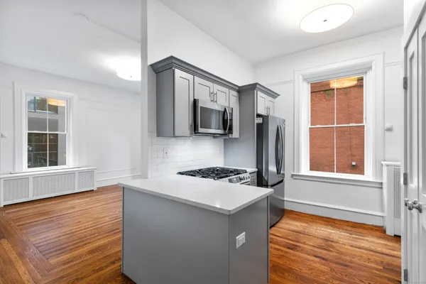 a kitchen with a stove a sink and a microwave