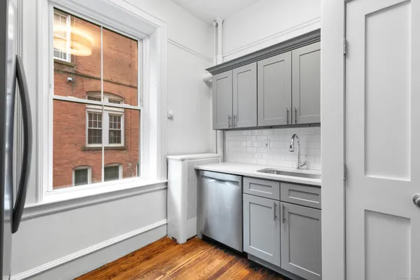 a kitchen with a sink cabinets and window
