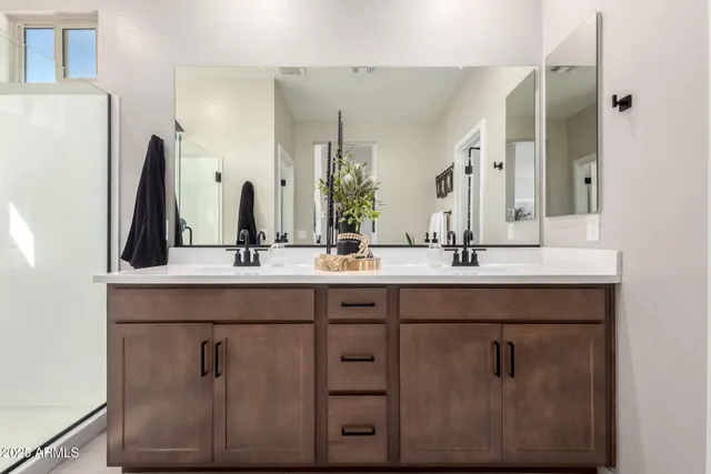 a bathroom with a double vanity sink and a mirror
