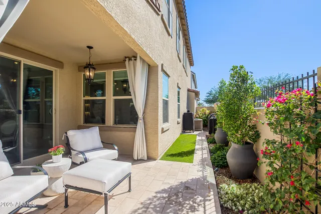 a view of a patio with couches chair and potted plants