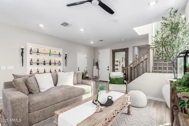 a living room with furniture and a potted plant
