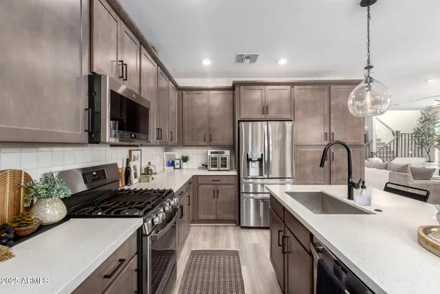 a kitchen with a sink stainless steel appliances and cabinets