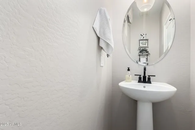 a bathroom with a sink a mirror and shower