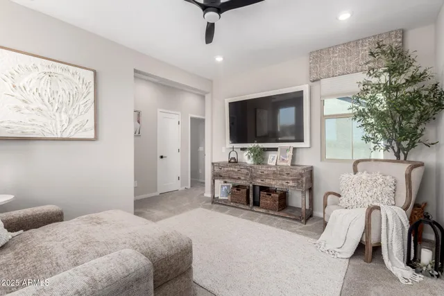 a bedroom with furniture and a flat screen tv