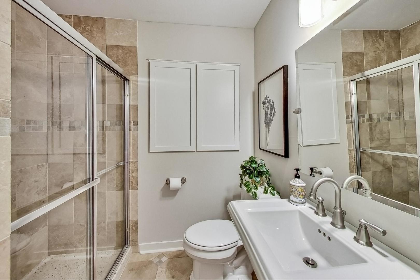 5040 Wolf Road Western Springs, IL 60558 - Photo 16 of 35 a bathroom with a sink toilet and shower