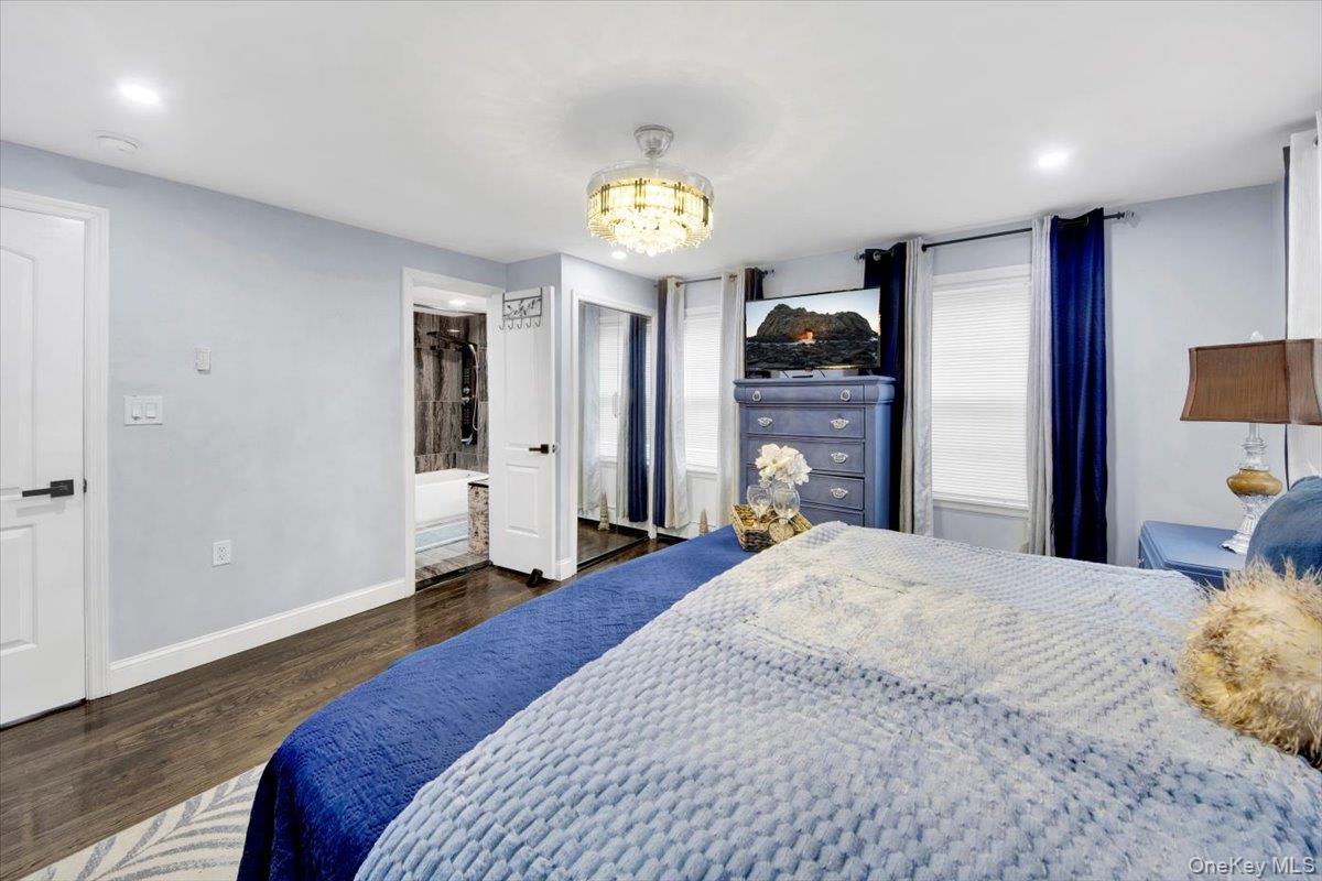 75 West Kingsbridge Road Mount Vernon, NY 10550 - Photo 23 of 37 Bedroom featuring dark wood-type flooring, a chandelier, and recessed lighting