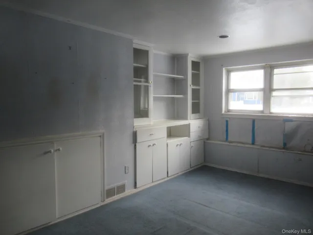 a room with a window and cabinet