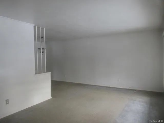 an empty room and a refrigerator