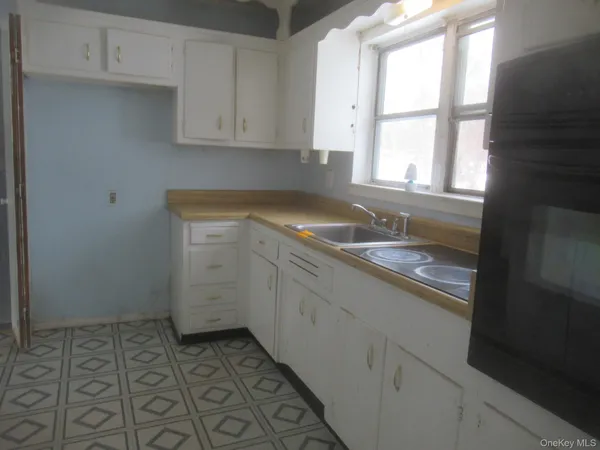 a kitchen with a sink and cabinets