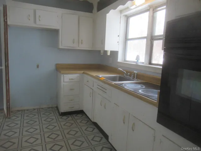 a kitchen with a sink and cabinets