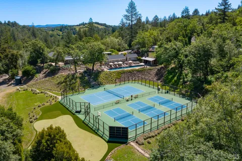 an aerial view of a house with swimming pool garden and mountain view