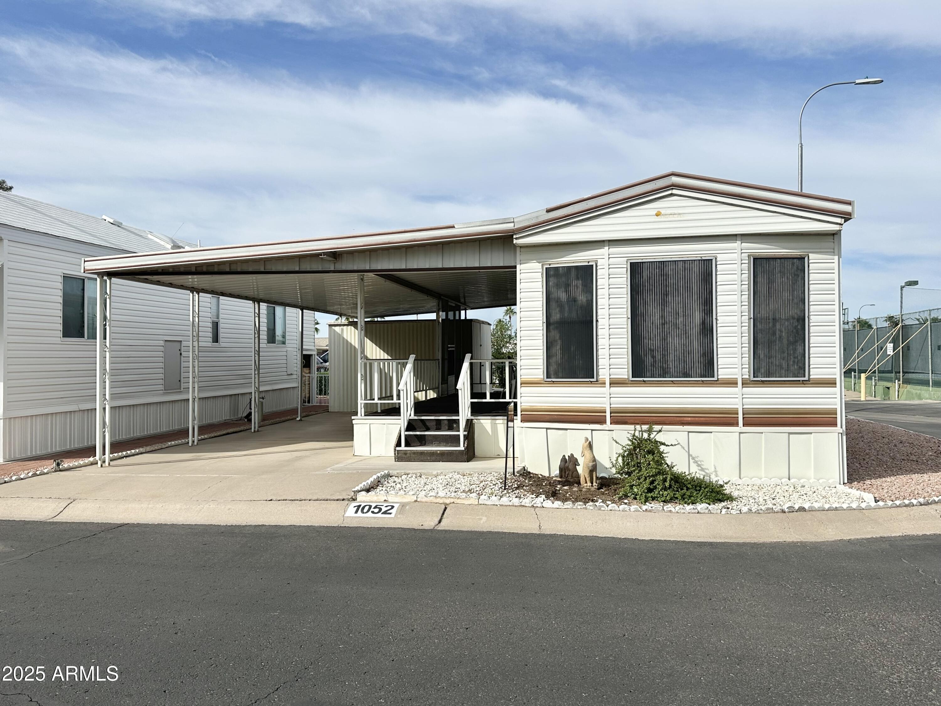 3710 South Goldfield Road, Unit 1052 Apache Junction, AZ 85119 - Photo 1 of 48 a house with a outdoor space