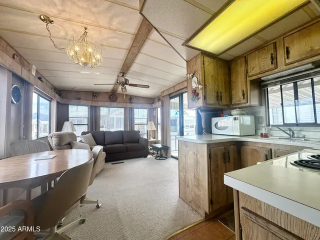 a kitchen with refrigerator a stove and chairs