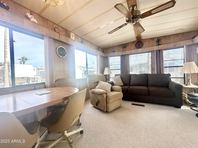 a kitchen with a sink appliances cabinets and a large window