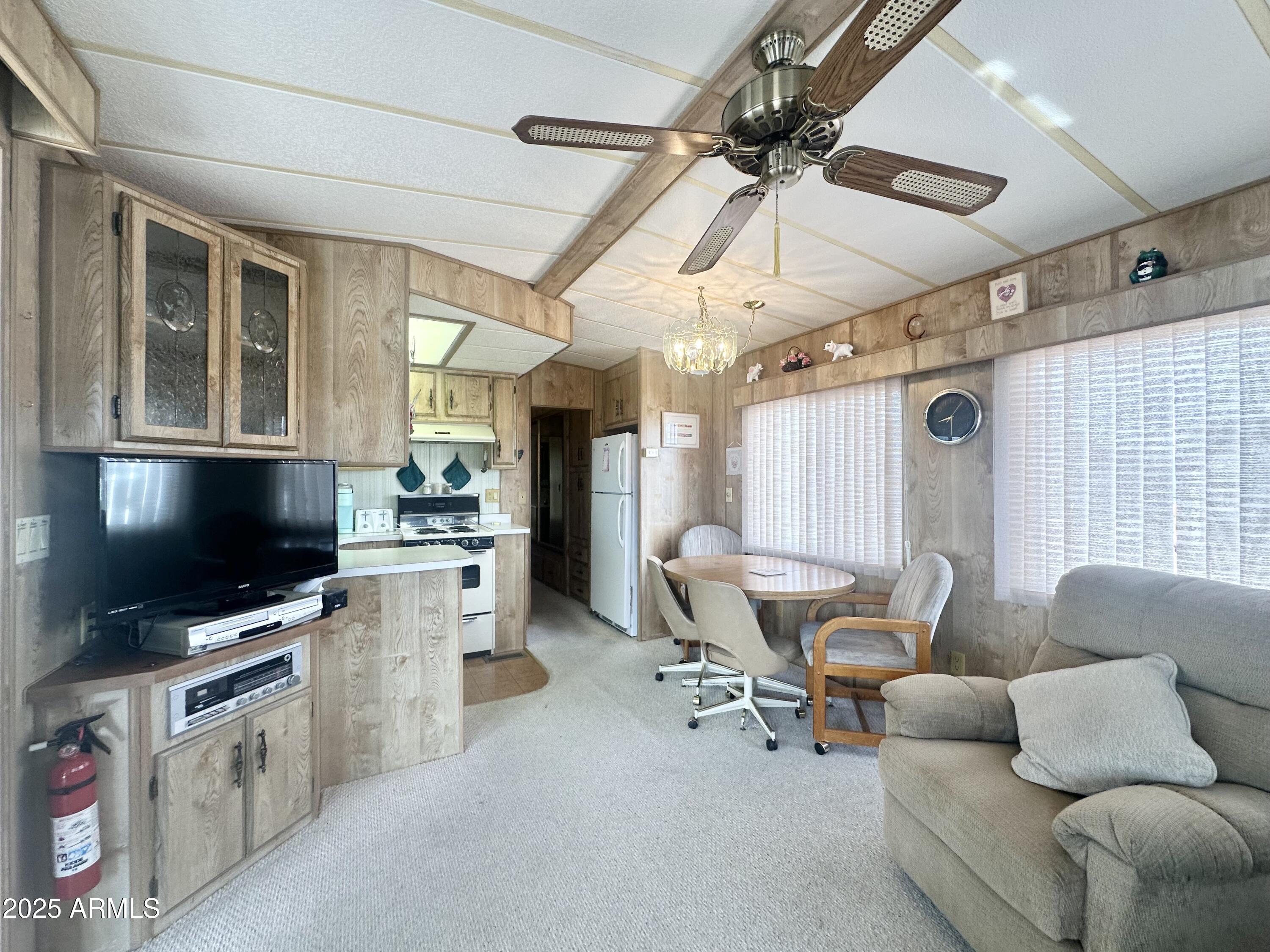 3710 South Goldfield Road, Unit 1052 Apache Junction, AZ 85119 - Photo 15 of 48 a living room with furniture and a flat screen tv