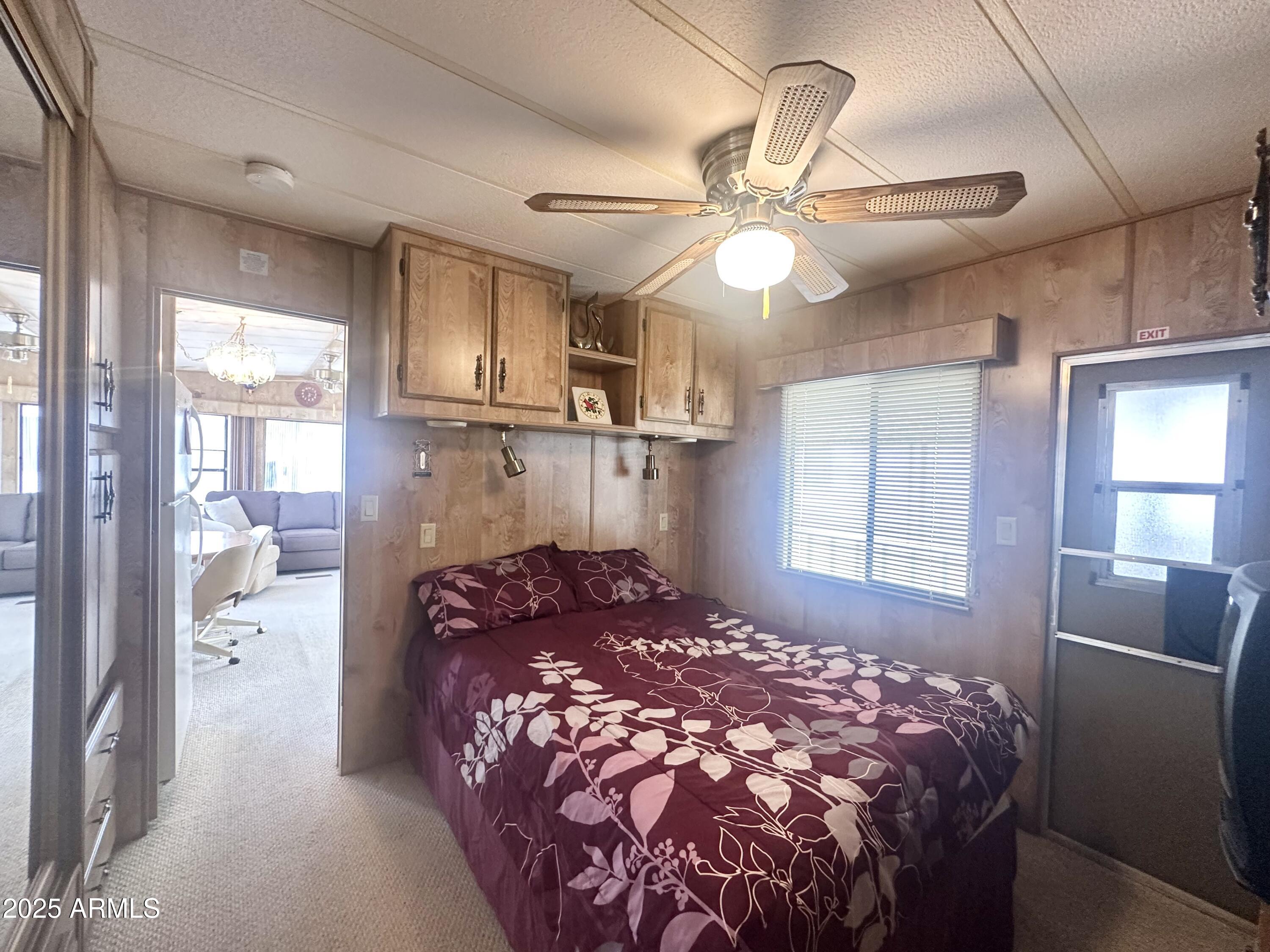 3710 South Goldfield Road, Unit 1052 Apache Junction, AZ 85119 - Photo 25 of 48 a bed sitting in a room next to a window