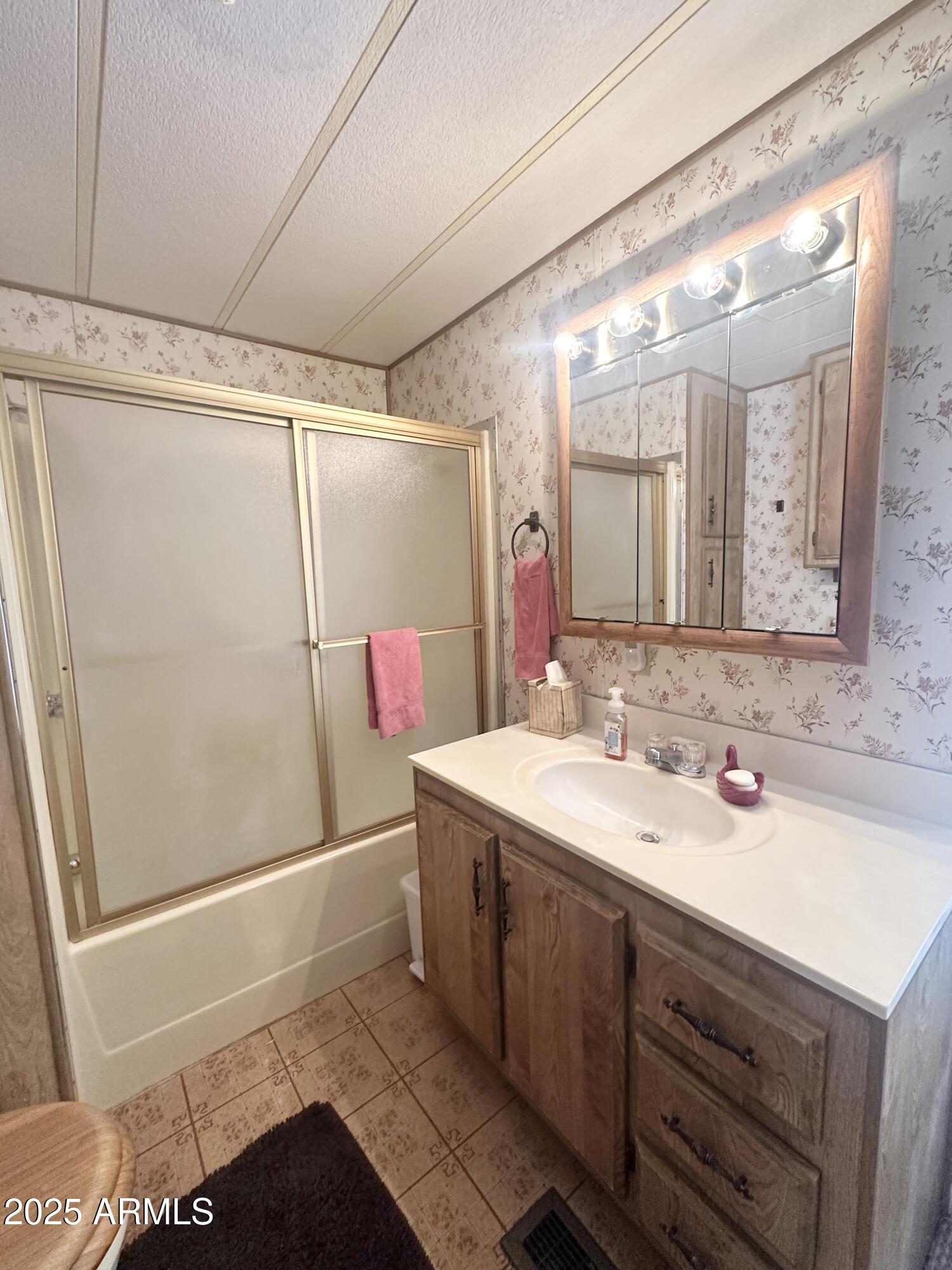 3710 South Goldfield Road, Unit 1052 Apache Junction, AZ 85119 - Photo 29 of 48 a bathroom with a sink and a mirror