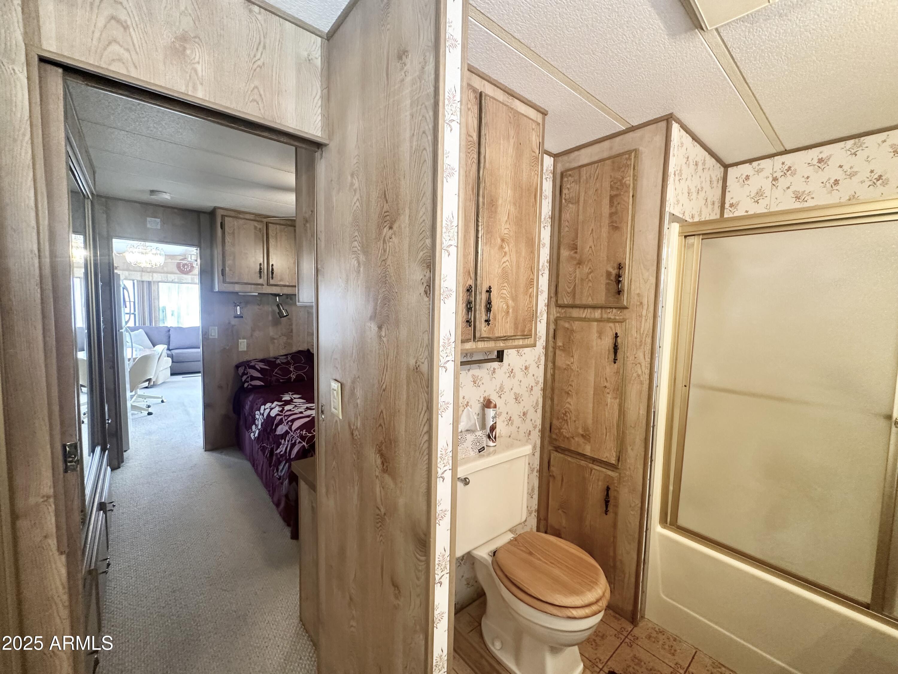 3710 South Goldfield Road, Unit 1052 Apache Junction, AZ 85119 - Photo 33 of 48 a bathroom with a toilet and a shower